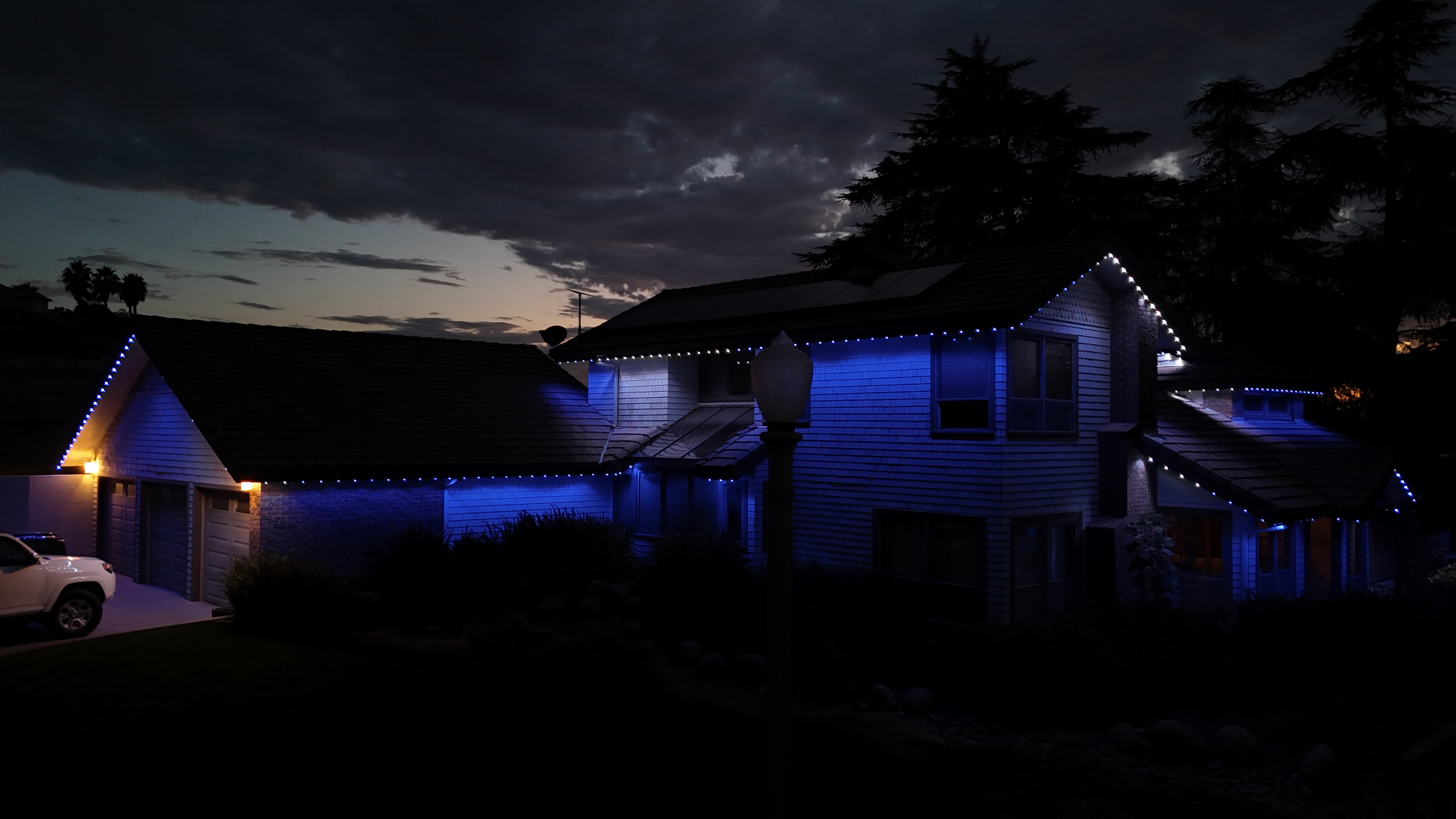 Exeter home cool blue permanent LED trim lighting at dusk