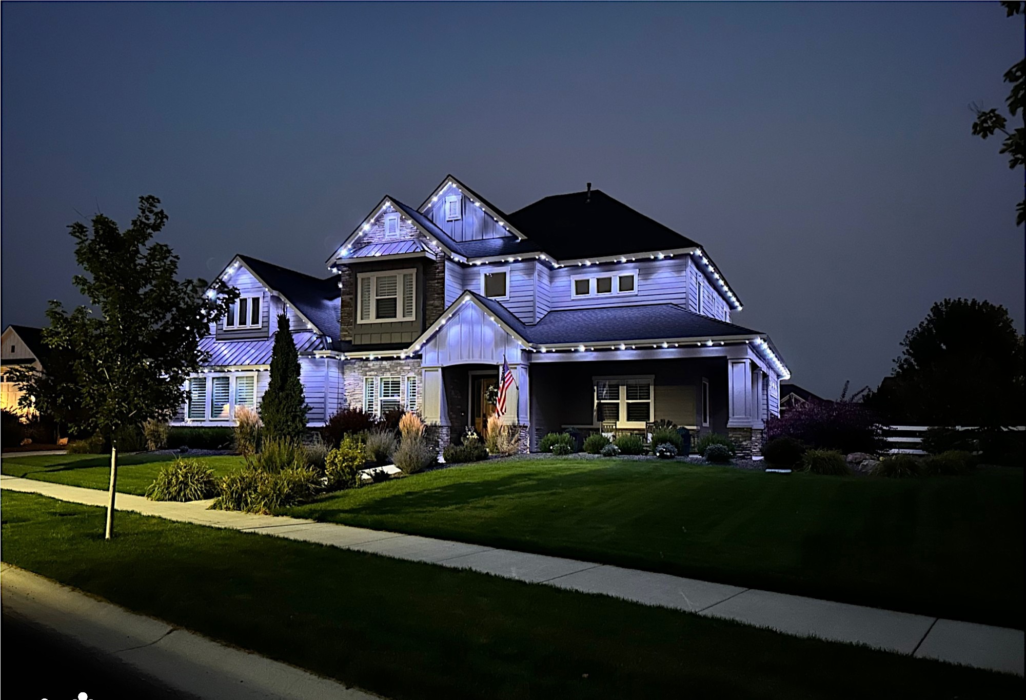 Cool white permanent LED trim lighting on suburban home